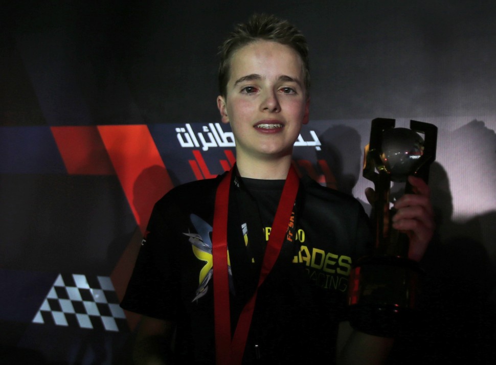 Luke Bannister of Somerset, a 15 year old British pilot of Bannisters team, Tornado X-Blades Banni UK, holds the trophy after he won the first World Drone Prix in Dubai, United Arab Emirates, Saturday, March 12, 2016. (AP Photo/Kamran Jebreili)