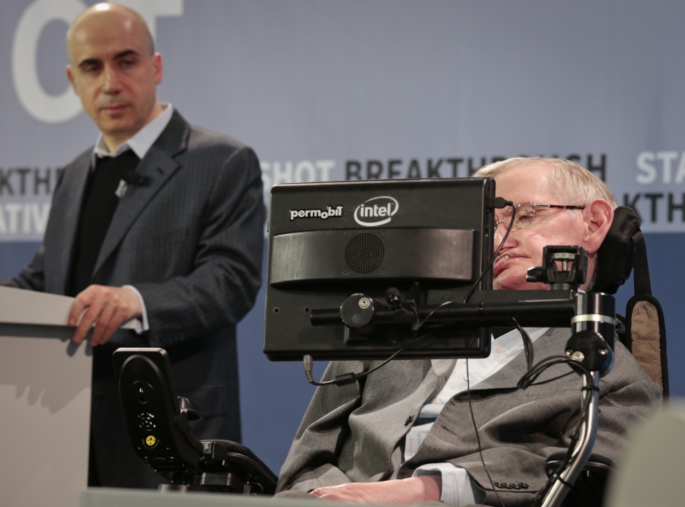 Internet investor and science philanthropist Yuri Milner, left, listens as renowned cosmologist Stephen Hawking, right, speaks with the assistance of adaptive speech technology, during a press conference announcing the new Breakthrough Initiative focusing on space exploration and the search for life in the universe, Tuesday April 12, 2016, at One World Observatory in New York. The $100 million project is aimed at establishing the feasibility of sending a swarm of tiny spacecraft, each weighing far less than an ounce, to the Alpha Centauri star system. (AP Photo/Bebeto Matthews)