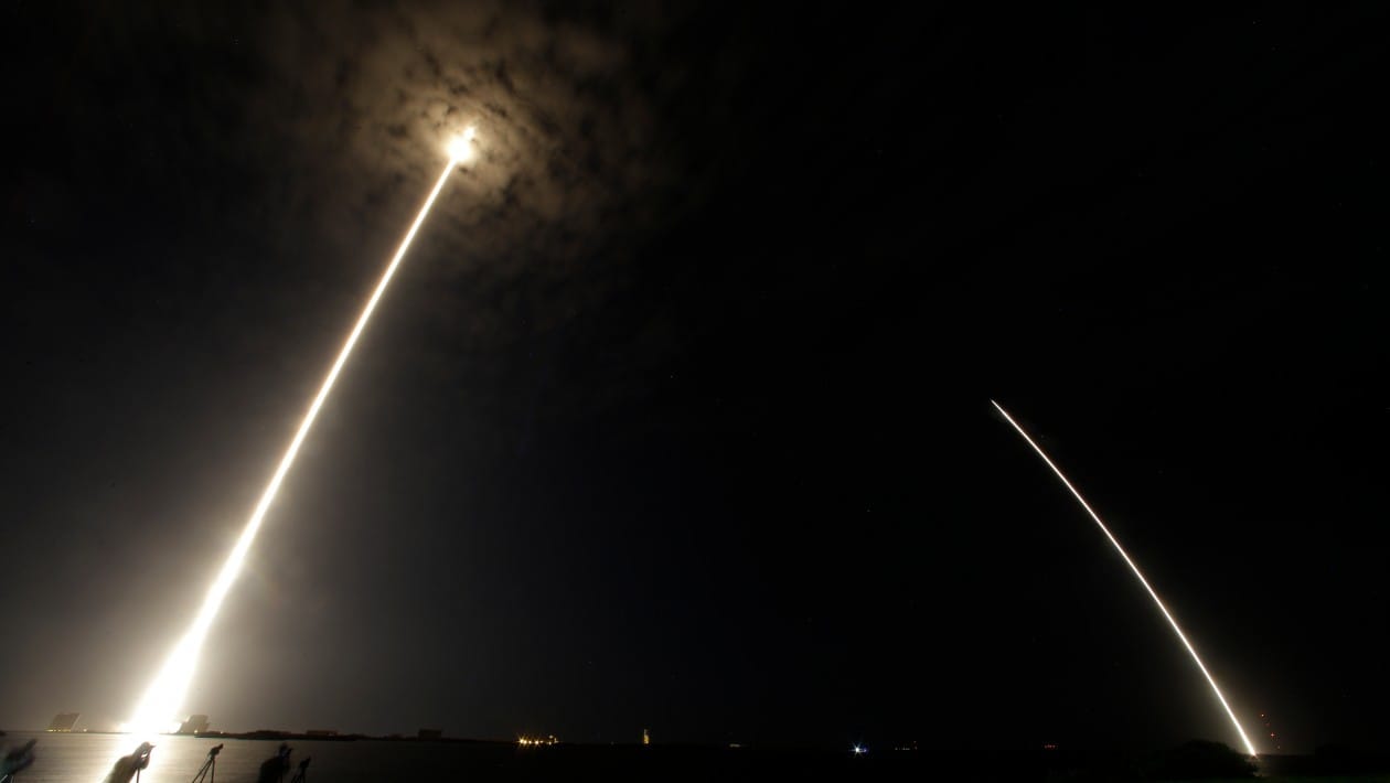 During a time exposure the Falcon 9 SpaceX rocket is seen, left, as it lifts off from launch complex 40 at the Cape Canaveral Air Force Station in Cape Canaveral, Fla., Monday, July 18, 2016. The streak on the right is the booster landing back at the Air Force Station. The Falcon 9 is headed to the International Space Station with 5,000 pounds of supplies. (AP Photo/John Raoux)