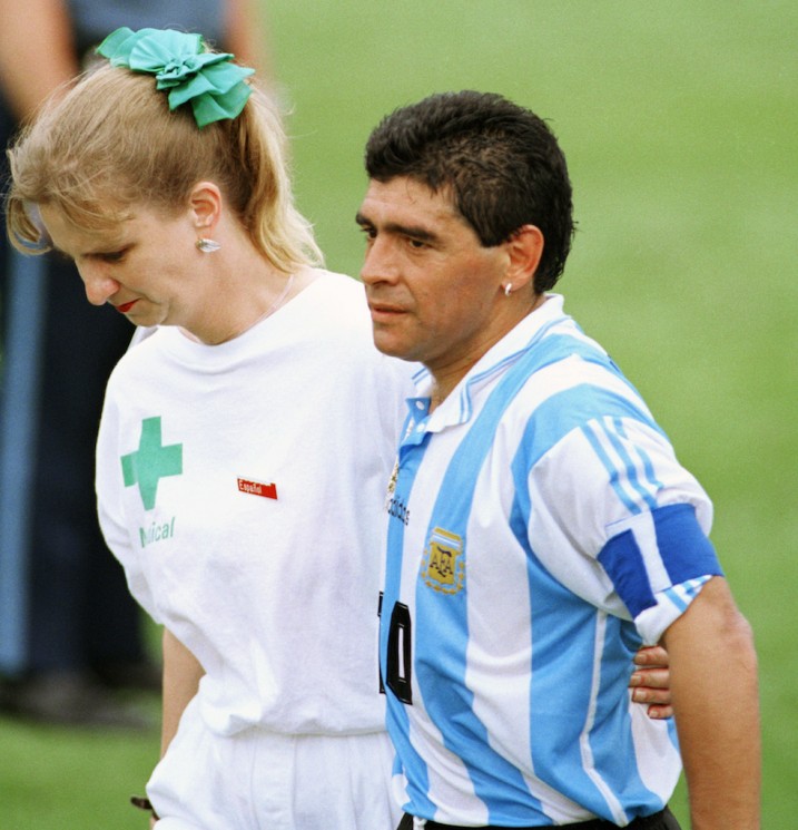 FILE - In this June 25, 1994, file photo, Argentine soccer star Diego Maradona, right, leaves the field of play for a random drug test at Foxboro Stadium with a medical technician of the International Soccer Federation (FIFA) after the team’s 2-1 win over Nigeria. He failed a doping test for five different banned stimulants and was thrown out the tournament. (AP Photo/Joe Cavaretta,File)