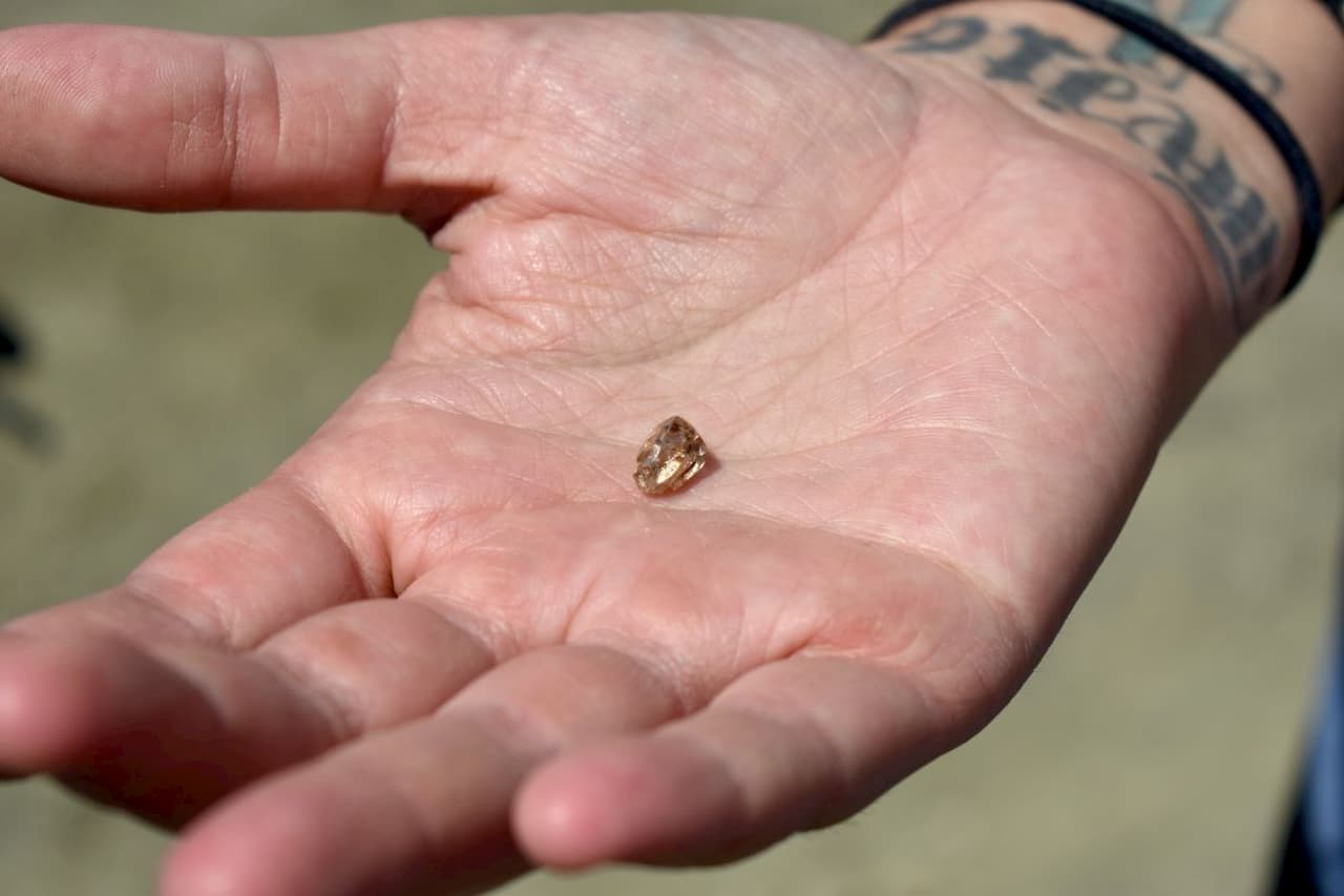 Diamante encontrado no Parque Estadual Crater of Diamonds nos EUA. Tamanho da pedra em comparação com a mão de uma pessoa