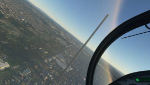 Vista aérea de Melbourne no jogo Flight Simulator. Um prédio muito mais alto que todos os seus arredores aparece no centro da imagem.