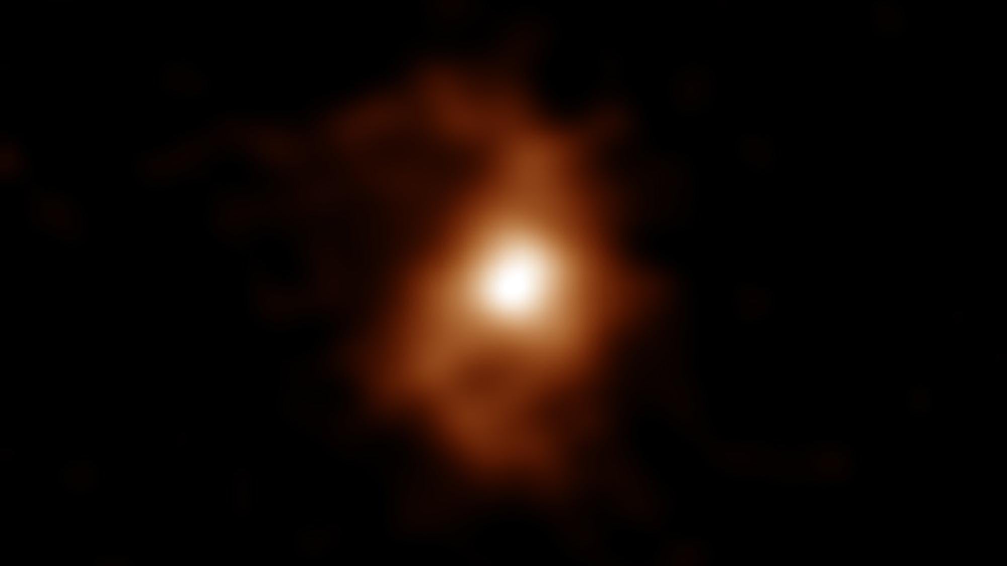 BRI1335-0417, uma galáxia primitiva com estruturas de braços espirais.