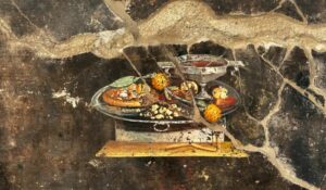 Pintura reveladora de ruína mostra "parente" de 2 mil anos da pizza redonda