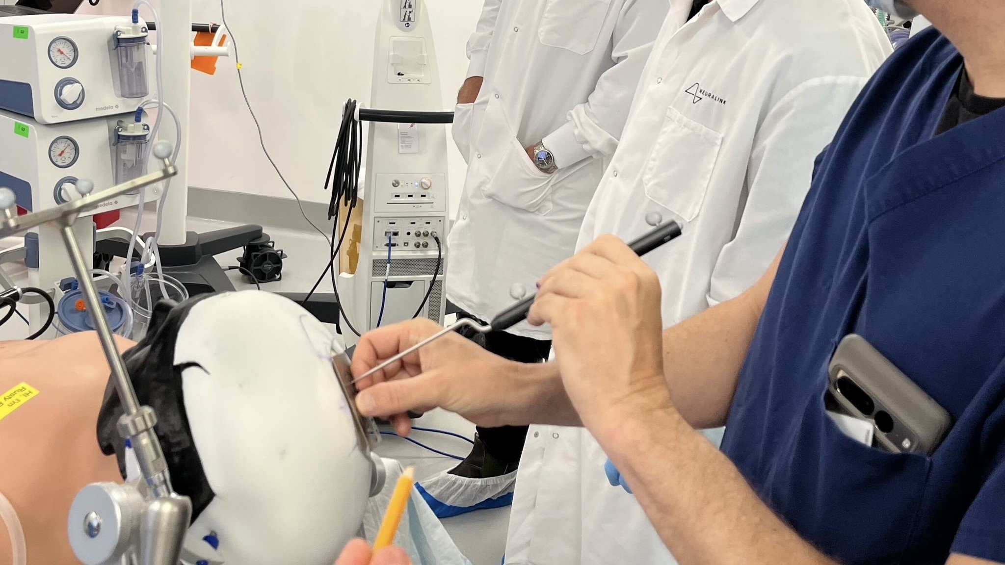 Médicos da Neuralink implantando chip em um boneco de treino